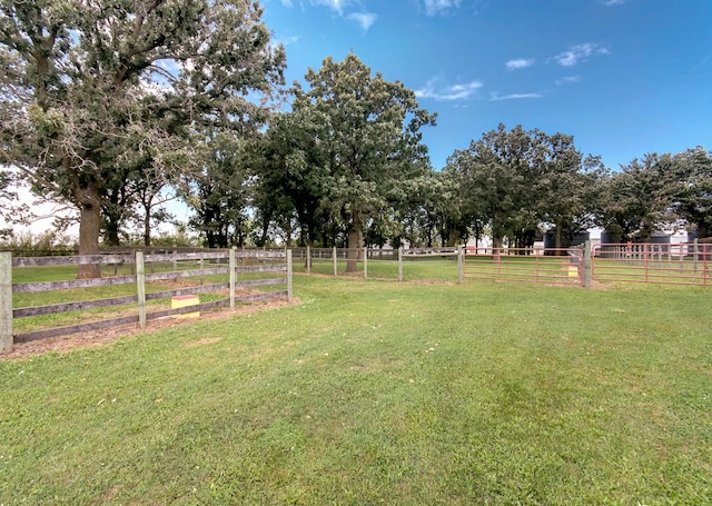 view of yard with a rural view and fence