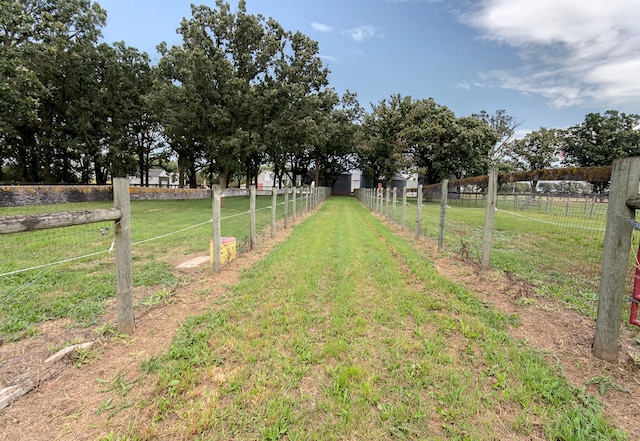 view of yard with a rural view and fence