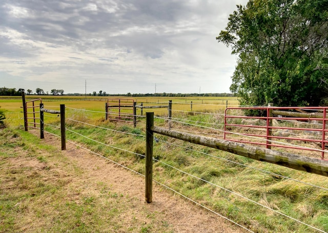 view of yard featuring a rural view and fence