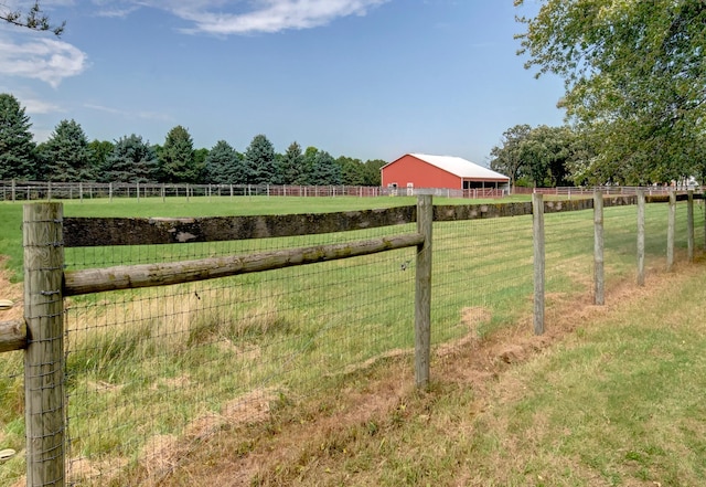 view of yard with a rural view and fence