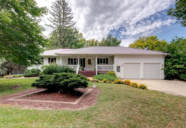 ranch-style house with a garage, concrete driveway, metal roof, covered porch, and a front yard