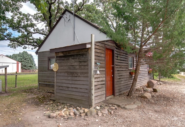 view of outbuilding featuring an outbuilding and fence