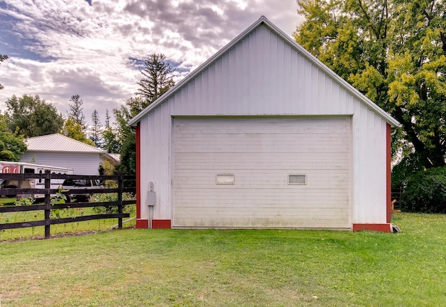 detached garage featuring fence