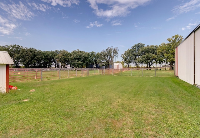 view of yard featuring a rural view and fence