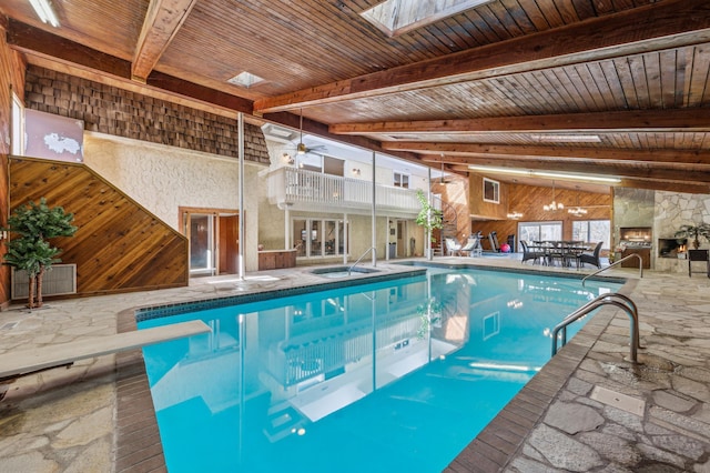 pool featuring a diving board and a skylight