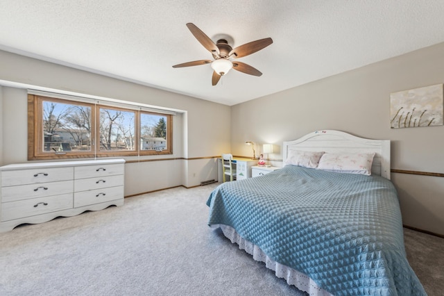 carpeted bedroom with a textured ceiling and ceiling fan