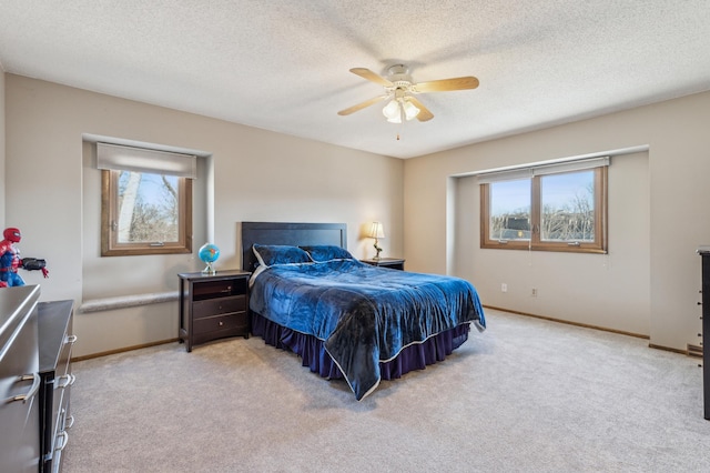 bedroom featuring light colored carpet and baseboards