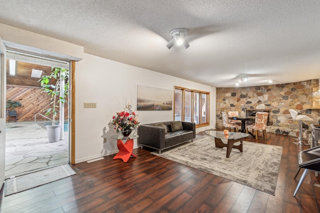 living area with a textured ceiling and hardwood / wood-style flooring