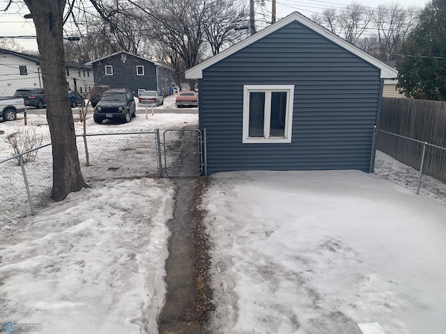 exterior space featuring driveway, fence, and a gate