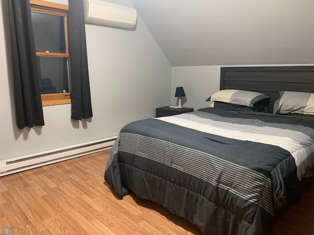 bedroom with vaulted ceiling, an AC wall unit, baseboard heating, and wood finished floors