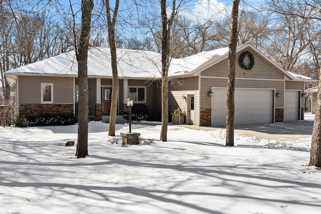 view of front facade featuring a garage and stone siding