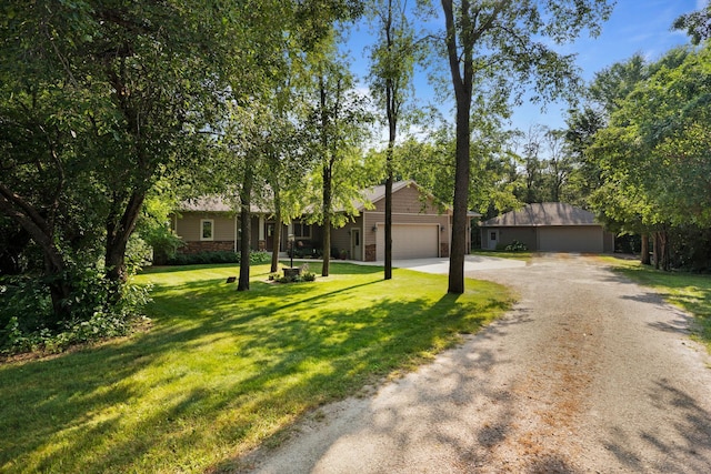 ranch-style house featuring a garage, a front yard, and driveway