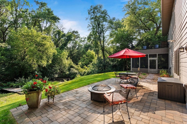 view of patio / terrace with a fire pit and outdoor dining area