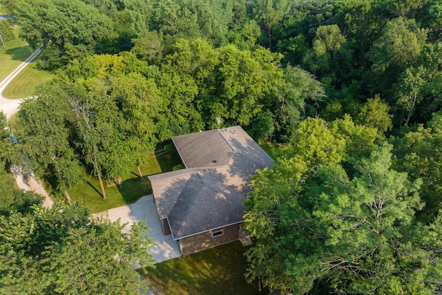 drone / aerial view with a wooded view