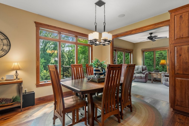 dining area featuring wood finished floors and an inviting chandelier