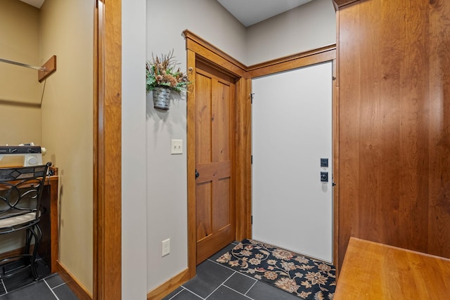 entryway featuring dark tile patterned floors