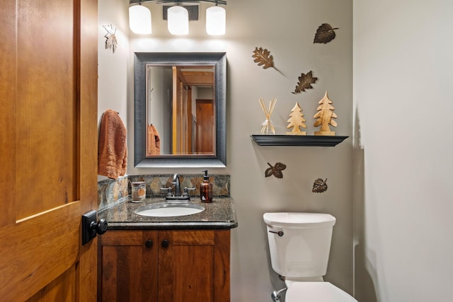 bathroom featuring toilet and vanity