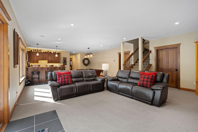 living area featuring recessed lighting, stairs, baseboards, and light colored carpet