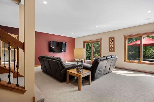 carpeted living room with stairs, baseboards, and recessed lighting