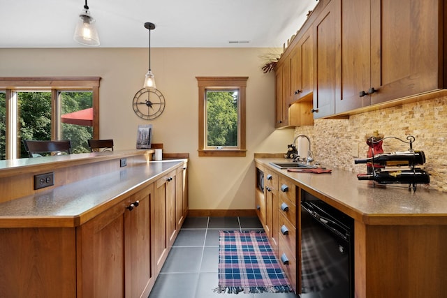 kitchen featuring visible vents, dishwasher, a sink, dark tile patterned floors, and backsplash