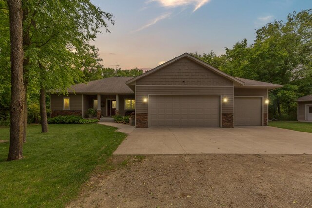 10060 82nd Ave, Ellendale, MN 56026 - view of front of house featuring concrete driveway, a garage, and a front lawn
