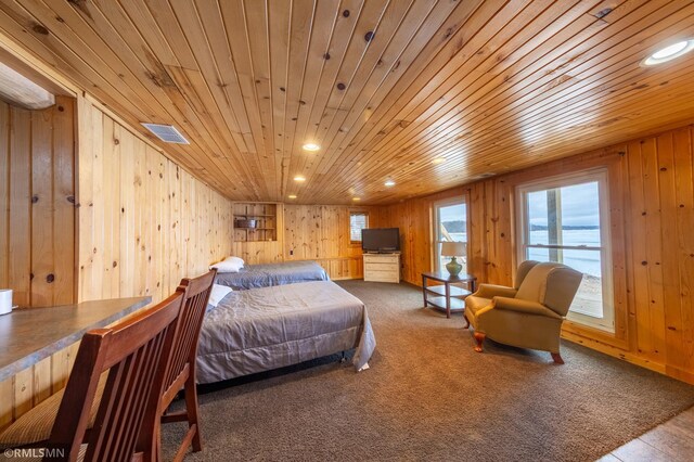 carpeted bedroom with wood walls, wooden ceiling, and recessed lighting