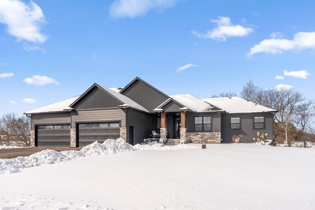 view of front of house with an attached garage and stone siding