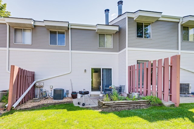 back of property with a yard, central AC unit, a patio area, and fence