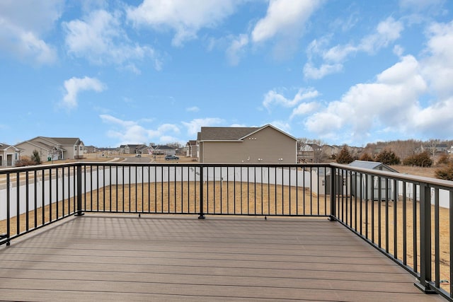 deck with a residential view and a lawn