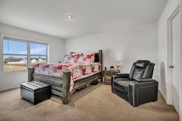 bedroom featuring carpet, a textured ceiling, and baseboards