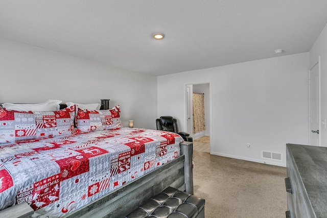 carpeted bedroom featuring visible vents and baseboards