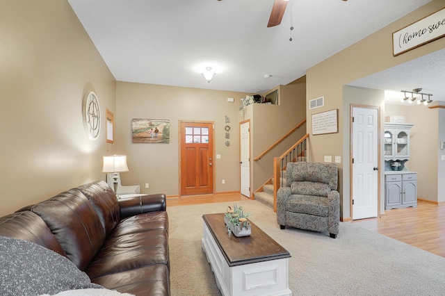5108 Harvest Curv, Mayer, MN 55360 - living room with light colored carpet, a ceiling fan, light wood-type flooring, visible vents, and stairway