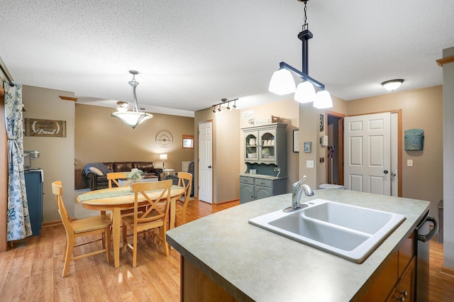 5108 Harvest Curv, Mayer, MN 55360 - kitchen featuring a textured ceiling, decorative light fixtures, a sink, and light wood-style flooring