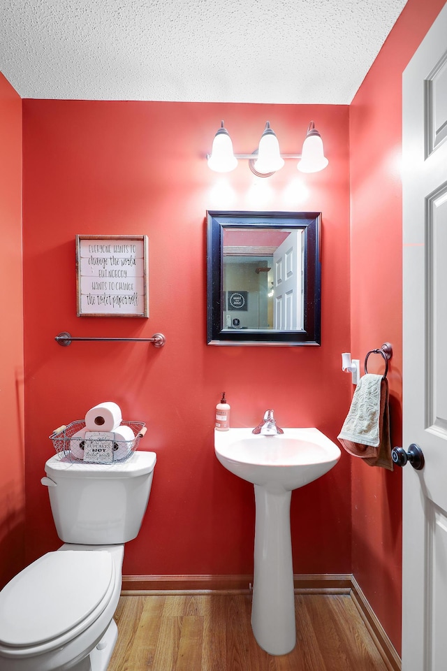 5108 Harvest Curv, Mayer, MN 55360 - bathroom with baseboards, a textured ceiling, wood finished floors, and toilet