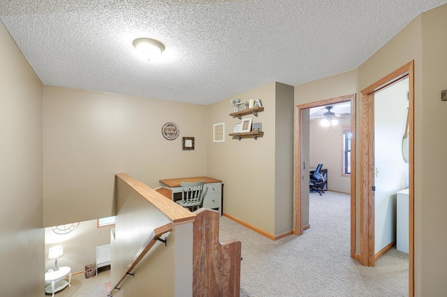 5108 Harvest Curv, Mayer, MN 55360 - corridor featuring light colored carpet, a textured ceiling, baseboards, and an upstairs landing