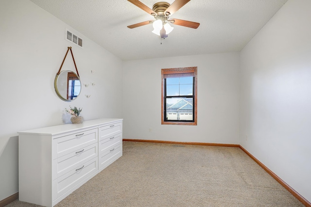 5108 Harvest Curv, Mayer, MN 55360 - unfurnished bedroom featuring visible vents, light carpet, baseboards, a textured ceiling, and a ceiling fan