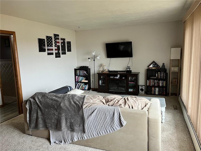 living room featuring a baseboard heating unit and carpet