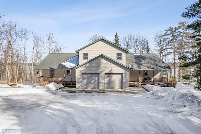 view of front of home featuring a garage, a porch, and a wooden deck