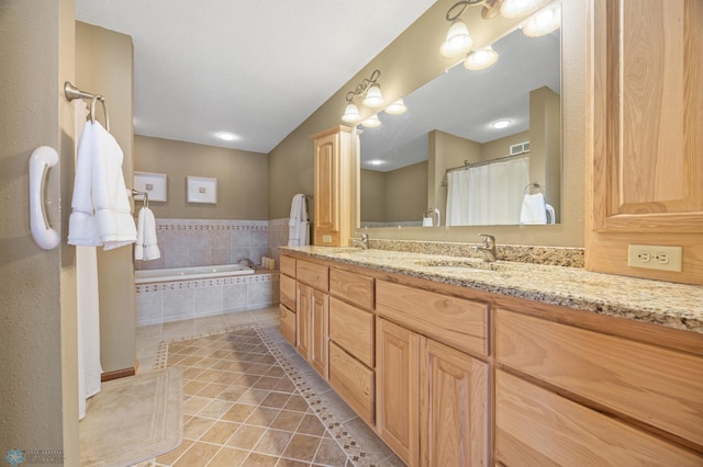 full bathroom featuring double vanity, a garden tub, a sink, and tile patterned floors