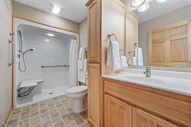 bathroom featuring curtained shower, vanity, and toilet