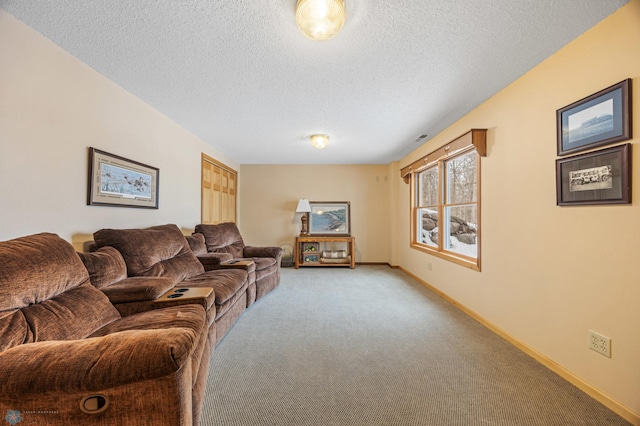 living area with a textured ceiling, carpet floors, and baseboards