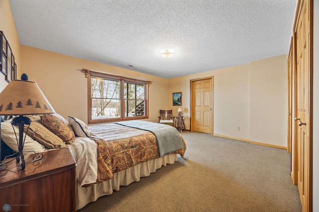 bedroom with visible vents, light carpet, a textured ceiling, and baseboards