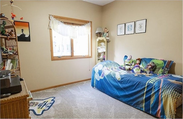 bedroom with carpet floors and baseboards