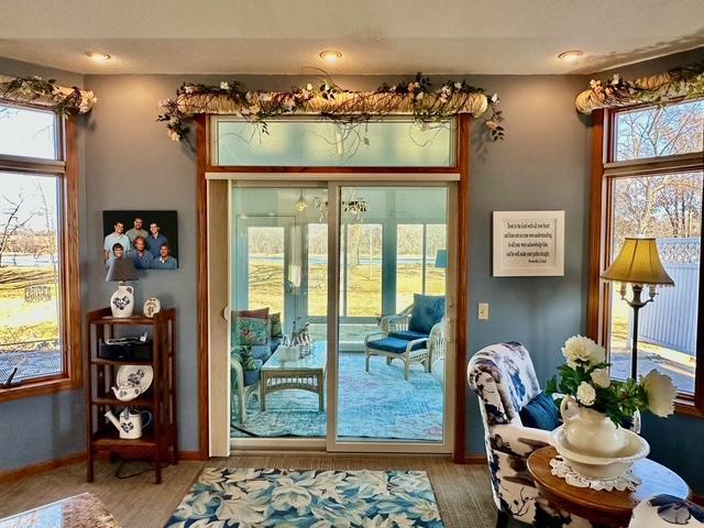 doorway to outside featuring baseboards and wood finished floors