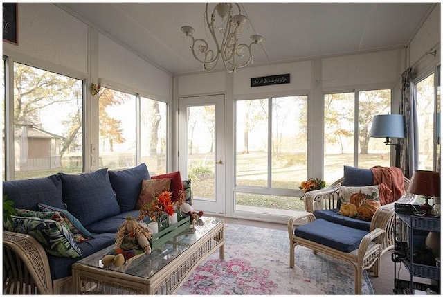 sunroom / solarium with lofted ceiling and an inviting chandelier