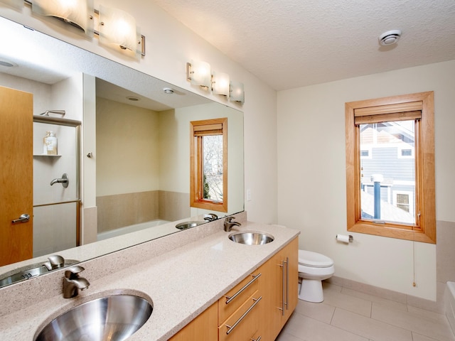 full bath with a garden tub and a sink