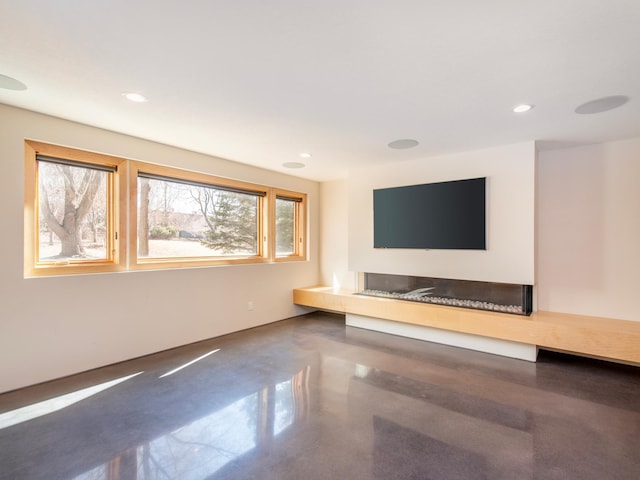 unfurnished living room with recessed lighting and finished concrete flooring