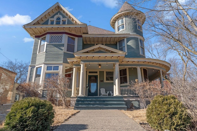 victorian-style house with a shingled roof and a porch