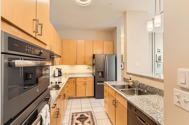 kitchen with light brown cabinets, light tile patterned floors, appliances with stainless steel finishes, and a sink