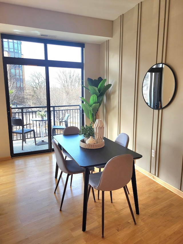 dining area featuring plenty of natural light and light wood-style floors